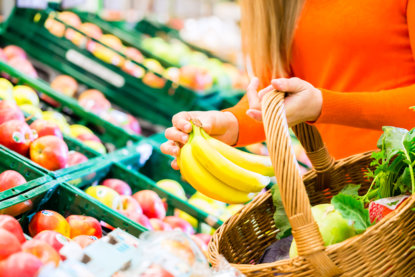 Woman in supermarket shopping groceries - 